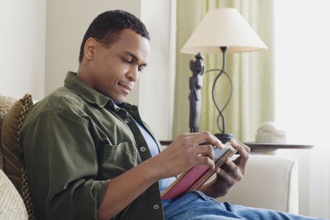 Man reading book at home. Photo: Rob Lewine