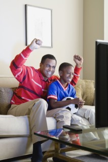 Father and Son (12-13) watching sports on tv. Photo: Rob Lewine