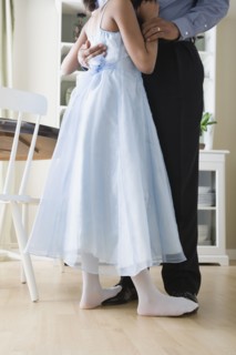 Low section of Father and Daughter (10-11) dancing in kitchen. Photo : Rob Lewine