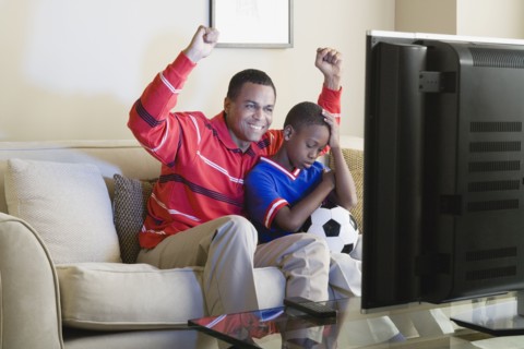 Father and Son (12-13) watching sports on tv. Photo: Rob Lewine