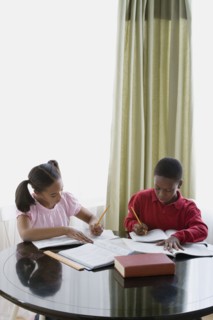 Brother and sister (12-13) doing homework. Photo : Rob Lewine