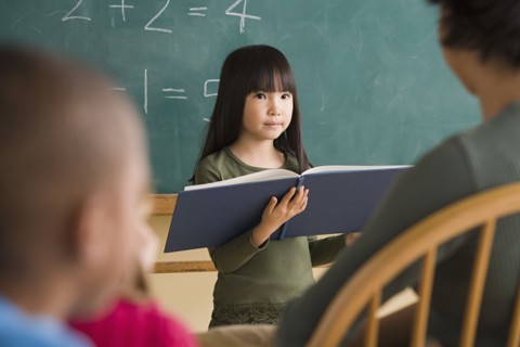 Girl (6-7) having presentation in classroom. Photo : Rob Lewine