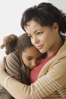Teacher comforting girl (6-7). Photo : Rob Lewine