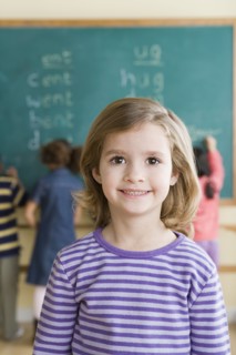 Portrait of girl (6-7) in classroom. Photo : Rob Lewine