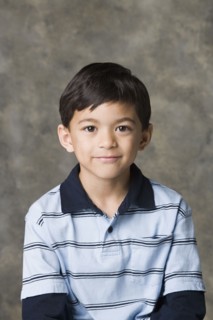 Portrait of smiling boy (8-9), studio shot. Photo : Rob Lewine