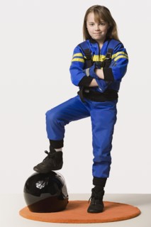 Portrait of girl (8-9) dressed as racing driver, studio shot. Photo : Rob Lewine