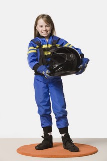 Portrait of girl (8-9) dressed as racing driver, studio shot. Photo : Rob Lewine