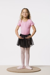 Studio portrait of smiling girl (8-9) in ballet costume. Photo : Rob Lewine