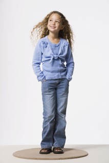 Studio portrait of smiling girl (8-9). Photo : Rob Lewine