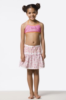 Studio portrait of smiling girl (8-9) with hair buns. Photo : Rob Lewine