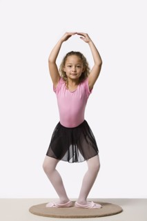Studio portrait of ballet dancer (8-9) exercising. Photo : Rob Lewine