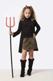 Studio portrait of girl (8-9) wearing Halloween costume with trident. Photo : Rob Lewine
