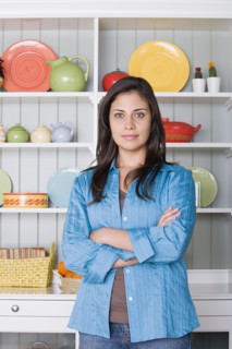 Portrait of smiling woman in kitchen. Photo : Rob Lewine