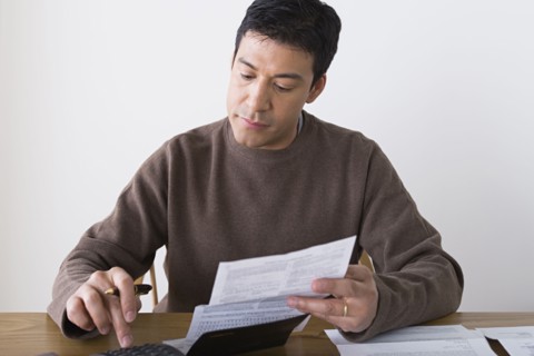 Man doing paperwork. Photo : Rob Lewine