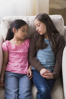 Girls (8-9, 10-11) sleeping in armchair. Photo : Rob Lewine