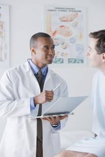 Male doctor talking to patient in hospital. Photo : Rob Lewine