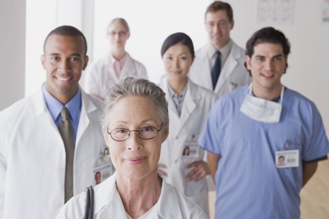 Group portrait of smiling doctors. Photo: Rob Lewine
