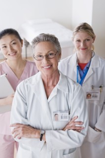 Portrait of three smiling female doctors. Photo : Rob Lewine