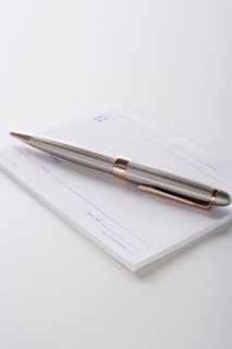 Close up of pen and blank prescriptions, studio shot. Photo : Rob Lewine