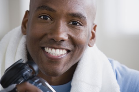 Portrait of smiling young man in gym. Photo : Rob Lewine