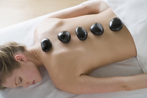 Woman receiving hot stone therapy. Photo : Rob Lewine