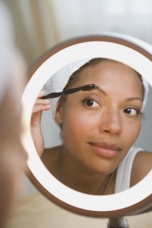 Woman brushing eyebrow. Photo : Rob Lewine
