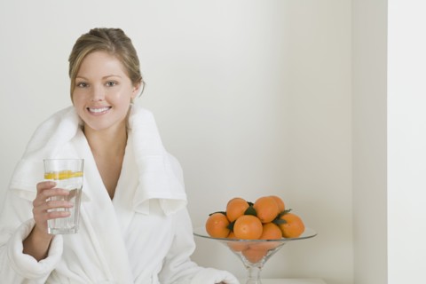 Relaxed woman drinking water. Photo : Rob Lewine
