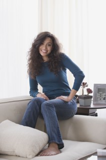 Woman relaxing on sofa. Photo : Rob Lewine