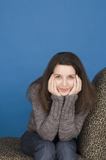 Portrait of teenage girl (16-17) sitting. Photo : Rob Lewine