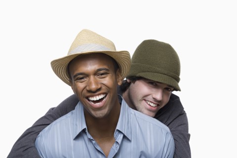 Studio portrait of two young men embracing. Photo : Rob Lewine
