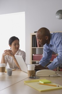 Two business people working in office. Photo : Rob Lewine