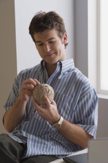 Portrait of businessman with ball of wool. Photo: Rob Lewine