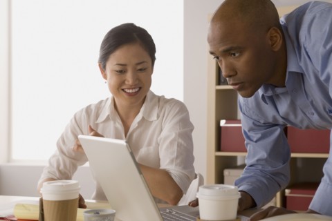 Two business people working in office. Photo : Rob Lewine