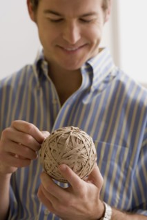 Young man holding ball made of paper. Photo : Rob Lewine