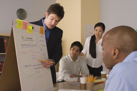 Group of businesspeople in meeting. Photo : Rob Lewine