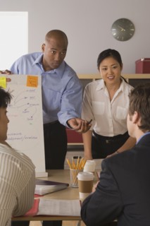 Group of businesspeople in meeting. Photo : Rob Lewine
