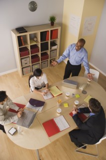 Group of businesspeople in meeting. Photo : Rob Lewine