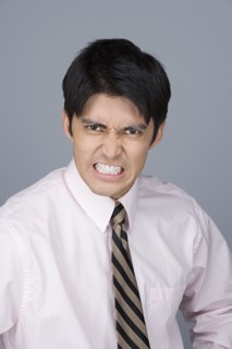 Portrait of young businessman pulling funny faces. Photo: Rob Lewine