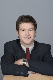 Portrait of happy young businessman. Photo : Rob Lewine