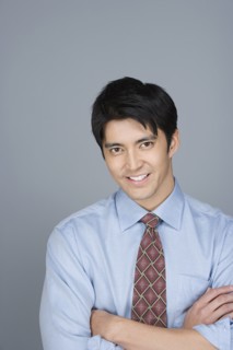 Portrait of happy young businessman. Photo : Rob Lewine
