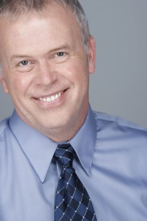 Portrait of happy mature businessman. Photo : Rob Lewine