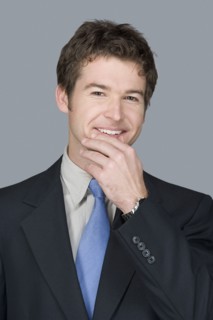 Portrait of happy young businessman. Photo : Rob Lewine