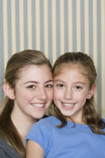 Portrait of two happy girls (14-15, 8-9). Photo : Rob Lewine