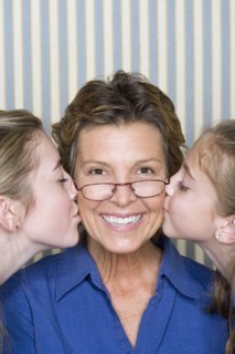 Portrait of father being kissed by two girls (8-9, 14-15) . Photo: Rob Lewine