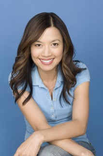 Portrait of happy asian woman wearing blue polo shirt. Photo : Rob Lewine