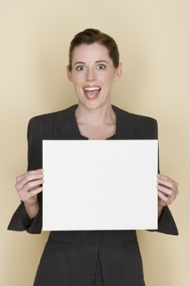 Portrait of happy mid adult woman holding blank sheet of paper. Photo : Rob Lewine