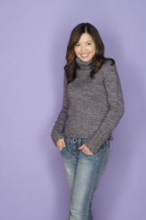 Portrait of happy asian woman wearing wooly jumper. Photo : Rob Lewine
