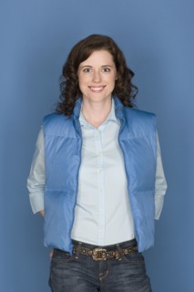 Portrait of happy mid adult woman wearing blue vest. Photo : Rob Lewine