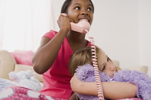 Two girls (10-11) having fun at slumber party. Photo : Rob Lewine