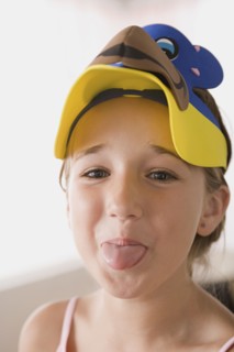 Portrait of smiling girl (10-11) sticking out tongue. Photo : Rob Lewine